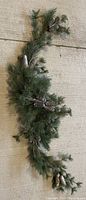60-inch artificial evergreen garland with pine cones and sprinkle of frost effect on some needles and cones.