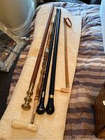 Photo of five canes laid out showing variety of shafts and handle styles