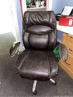 Front view of Serta leather office chair showing padded seat, backrest, and armrests