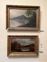 Two framed landscape paintings; upper canvas 12.5x7.5 inches in gold ornate frame 16x22 inches with visible chipping; lower board painting 9x15 inches framed 14x20 inches with small corner chip.