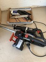 Photo shows Ferrex electric chainsaw and Ironton saw side by side with blades attached and power cords visible.