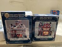 Two original boxed Norman Rockwell figurines from The Saturday Evening Post Freedom Series, featuring artwork titles on the boxes.