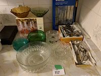 View of miscellaneous glass bowls, cutlery, boxed sets, and knife set