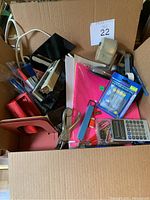 Wide view of the lot showing all items including staplers, hole puncher, pens, calculator, tape dispenser, and folders.