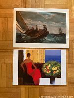 Photo of two larger prints showing a sailing scene with men in boat and an indoor scene with woman in red dress and fruit