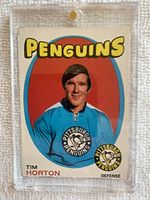 Front of 1971-72 O-Pee-Chee #186 Tim Horton hockey card in protective plastic holder, showing player wearing Pittsburgh Penguins blue jersey with team logos and card details.