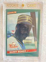 Front of 1986 Donruss Rookies #11 Barry Bonds baseball card in a clear magnetic rookie card holder showing player's portrait and team details.