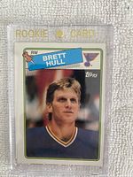 Front of the 1988-89 Topps Brett Hull rookie card showing the player in St. Louis Blues uniform inside a clear magnetic holder with 'ROOKIE CARD' printed on the holder.