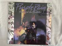 Front cover of the Purple Rain vinyl showing Prince on a motorcycle with purple lighting and smoke effects.