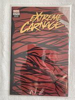 Full front cover view of the Extreme Carnage: Alpha comic with symbiote variant cover, showing red background with black stripes and gold lettering.