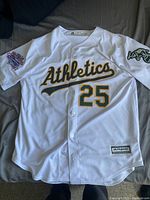 Front view of the white Majestic Coolbase Oakland Athletics jersey with custom embroidery and patches.