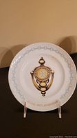 Front view of the decorative plate showing the doorknocker design and anniversary text