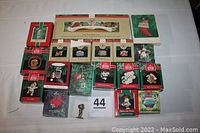 Photo showing all 18 Hallmark Keepsake Christmas Ornaments in original boxes arranged flat.