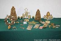 Full view of the holiday lot including trees, star, wreath, ornaments, and glass dish on green cloth