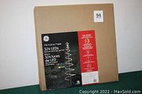 Box packaging showing the product as a 7 foot, 324 LED Dual Color Spiral Tape Light Tree by GE with star topper