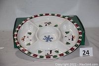 Front view of the round five-section ceramic serving platter decorated with white bears, Christmas trees, and snowflakes, bordered with a red and green pattern.