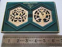 Two hexagonal silver-plated ornaments displayed in original green Reed & Barton box with velvet interior. The ornaments depict two different birds to represent two of the first six days of Christmas.