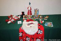 Full lot overview showing holiday headbands, Santa beard wig and hat, Mickey Mouse Santa pants, Snoopy night light and various holiday figurines including Winnie the Pooh Christmas train pieces