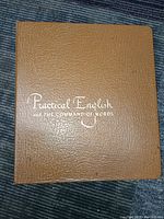 Brown textured binder titled 'Practical English and The Command of Words' on cover.