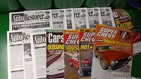 Overview photo showing 15 vintage car magazines laid out including Classic Auto Restorer, Super Chevy and Cars titles with muscle car covers