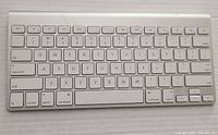 Front view of Apple Wireless Bluetooth Keyboard A1314 showing full key layout and aluminum top with white keys.