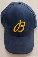 Front view of blue hat showing yellow 'B' embroidery on crown.