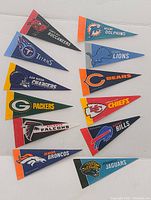 Mini pennants for Tampa Bay Buccaneers, Tennessee Titans, San Diego Chargers, Green Bay Packers, Atlanta Falcons, Denver Broncos, Miami Dolphins, Detroit Lions, Chicago Bears, Kansas City Chiefs, Buffalo Bills, Jacksonville Jaguars.