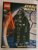 Box of Lego Star Wars Darth Vader set number 8010, showing image of the assembled figure holding a red lightsaber and details including piece count and age recommendation.