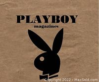 Close-up of black Playboy bunny logo on a tan background, presumably a box or cover for the ashtrays.