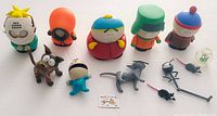 Wide shot of all South Park vinyl figures and assorted animal and mini figures placed on a white surface