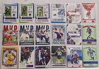 Top-down view of assorted NBA and NFL card inserts arranged in rows on a table, showcasing front designs of cards from Ticket Masters, MVP, Rookie Status, and other series