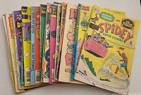 Top fanned view of the lot of vintage comic books showing front covers including Marvel Comics and other titles