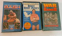 Three VHS tapes shown: The Great American Bash 1986, Roddy Piper's Greatest Hits, War Games