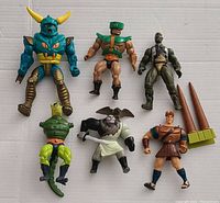 Six vintage action figures displayed on white surface, showing full body and accessories.