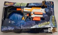 Nerf Recon MKII blaster in original packaging, box crushed and damaged.