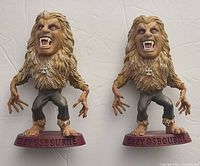 Photo showing both Ozzy Osbourne Headliner figures side by side on a white surface.