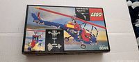 Top view of original LEGO 8844 Expert Builder Set box showing helicopter model built with blue beams, red and yellow pieces, and rotors.