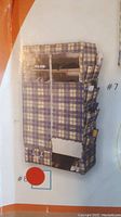 Photo of the assembled portable wardrobe covered with plaid non-woven fabric showing compartments and storage sections.