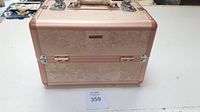 Closed Sephora makeup case on white surface showing full front and top handle.
