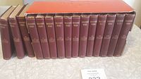 Photo showing 15 volumes with maroon covers and gold titles on the spine, set of Shakespeare's works.