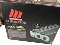 Front of the original Motomaster Eliminator 1100 W power inverter box showing main branding, power output, and features.