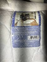 Close-up of lambskin rug label showing care instructions and sample room setting