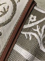 Close-up shot showing woven polypropylene texture and brown edge binding of mats