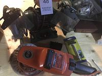 Photo showing the green 6-inch bench grinder with two grinding wheels and clear protective shields.