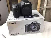 Canon EOS 7D body atop original EOS 7D box, showing front and grip