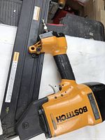 Framing nailer from left side on white background showing body and magazine