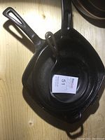 Three cast iron skillets stacked, showing size differences.