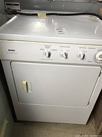 Front view of the Kenmore white electric clothes dryer showing door and control panel.
