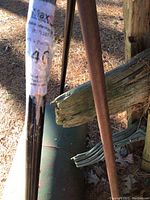 Sticker with MaxSold inventory details on lawn roller handle.