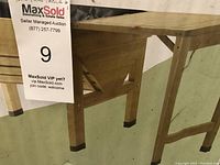 Photo of wooden cedar side table with black capped feet and cross bracing supports on legs.